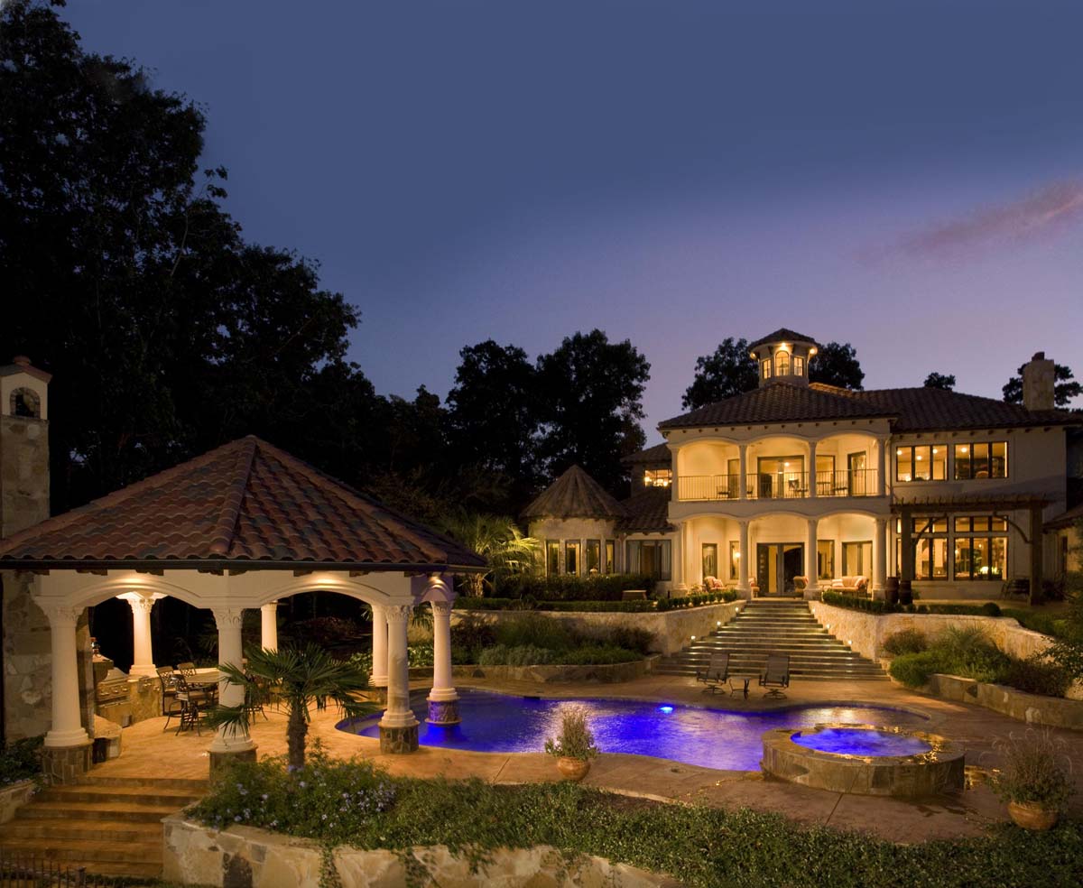A mansion with two pools near the patio